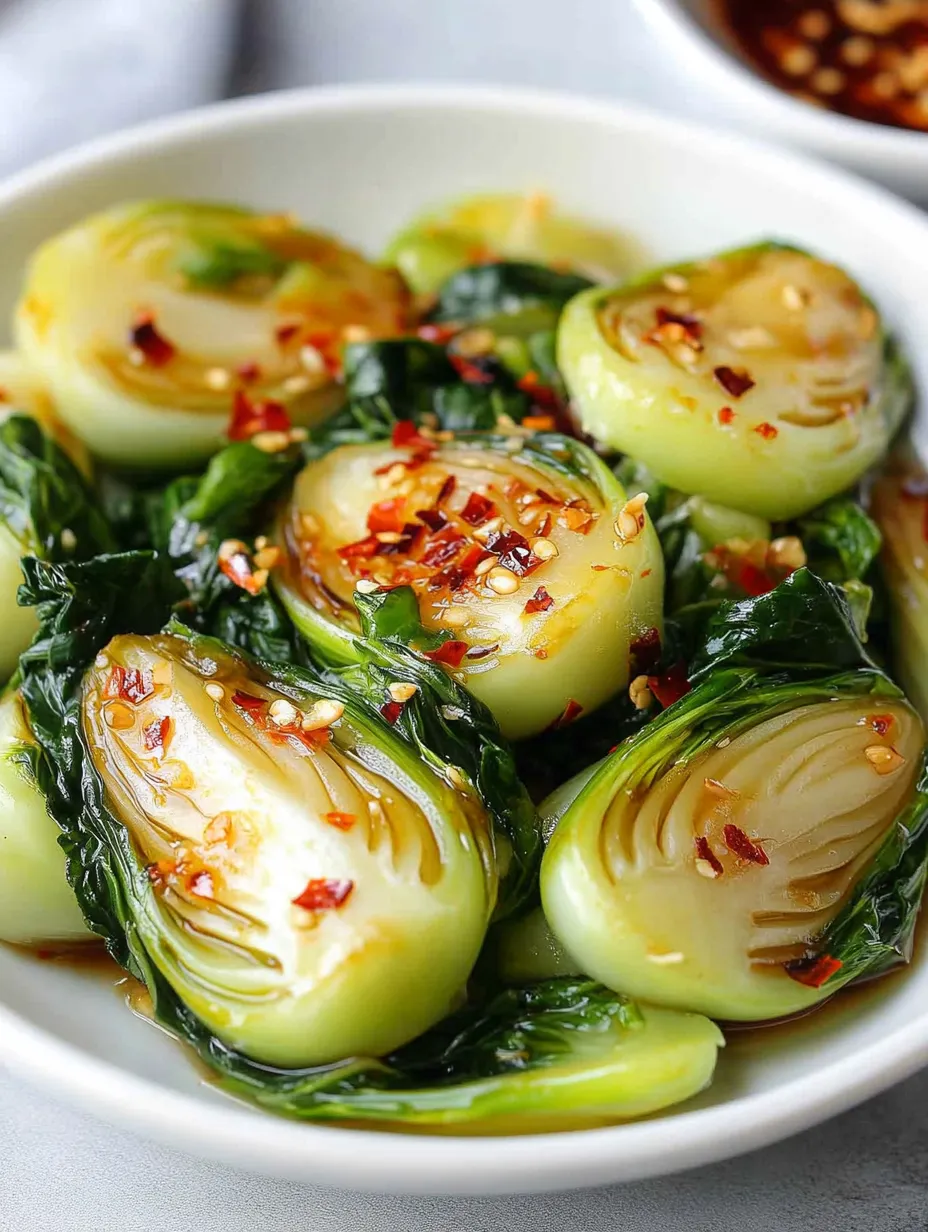 A bowl of food with a variety of vegetables, including broccoli, onions, and peppers, all covered in a spicy sauce.