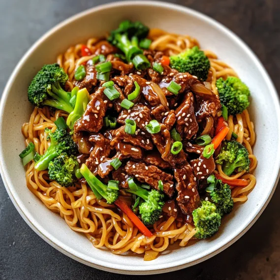 A filled bowl of chewy noodles featuring veggies and tender beef.
