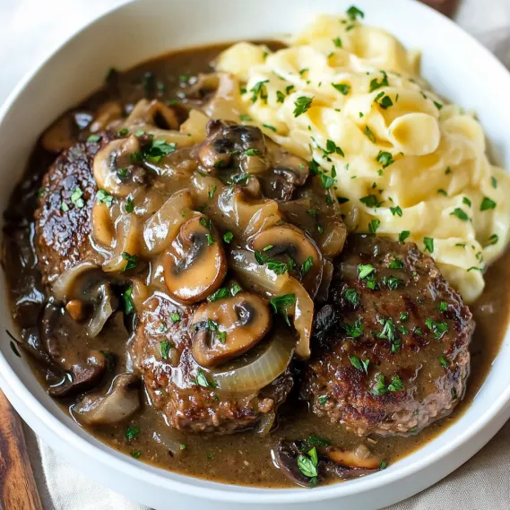 A plate of noodles topped with mushrooms and a savory sauce.