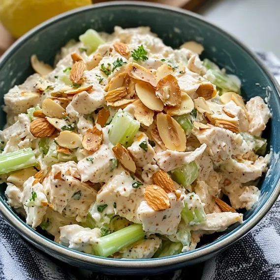 A bowl with chicken and almond salad.