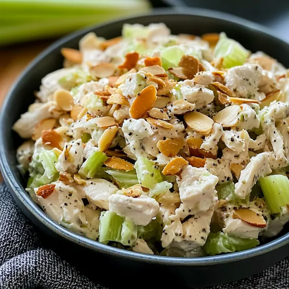 A bowl of food with a green vegetable.
