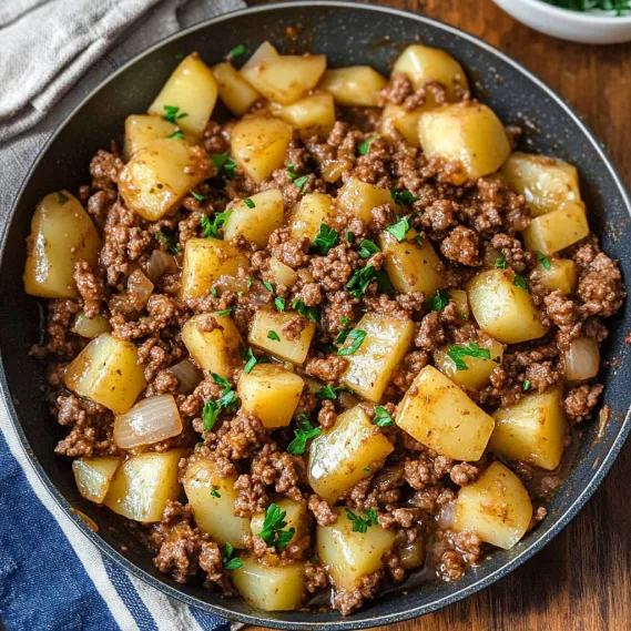 A bowl filled with beef and potatoes.