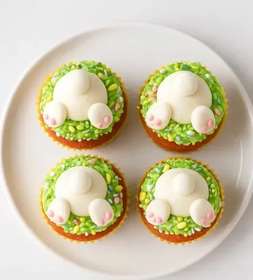 Cupcakes with green frosting and pink frosting.
