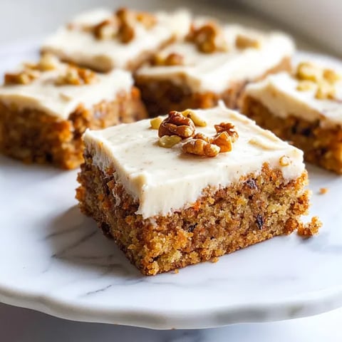 A cake slice topped with nuts.
